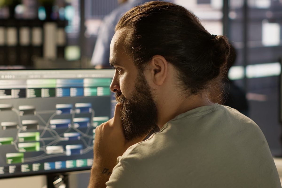 Close up of system administrator transforming data into predictive models System administrator working with machine learning artificial intelligence critical to autonomous systems. Close up of man transforming data into predictive models, camera A