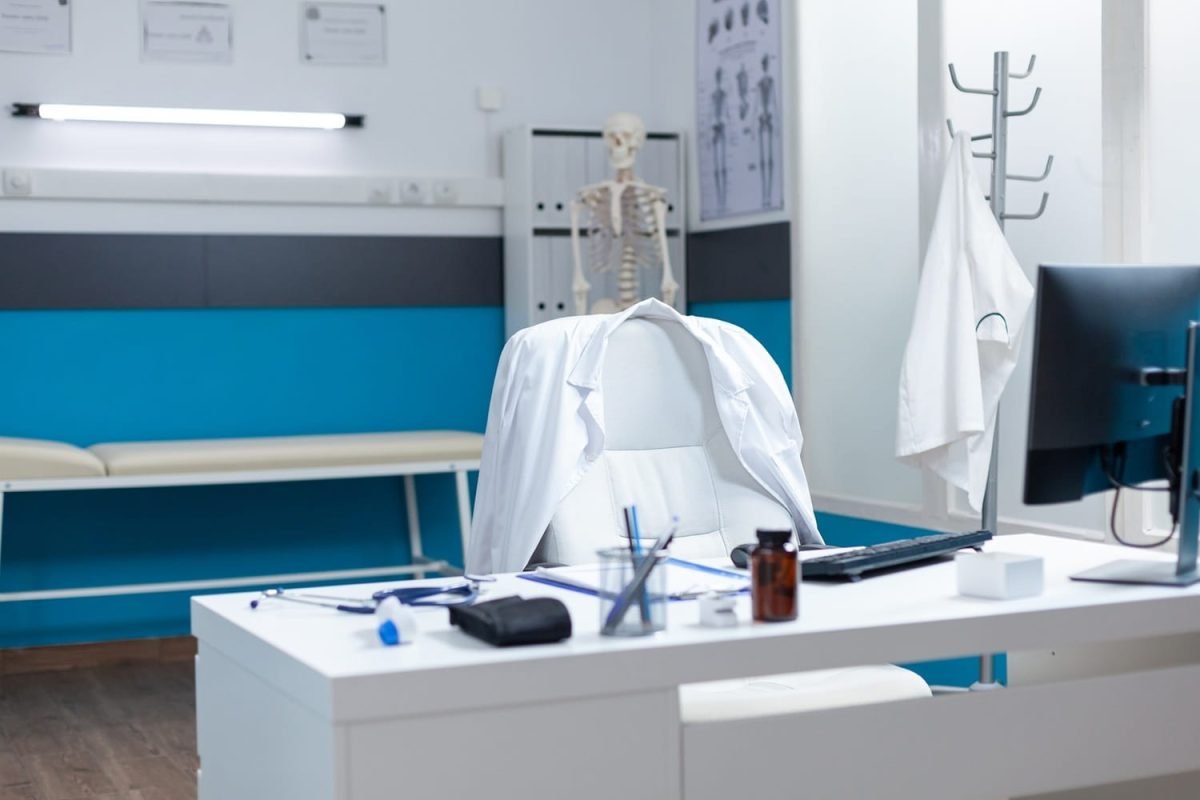 Empty modern medical office having disease documents Empty modern medical office having disease documents on table equipped with contemporary furniture. Hospital workplace with nobody in it ready for sickness consultation. Medicine support